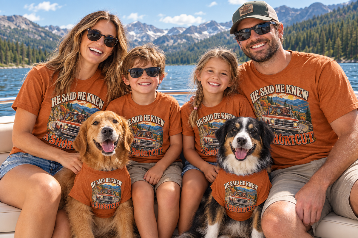 Family and two dogs wearing matching He Said He Knew a Shortcut T-shirts on a boat ride