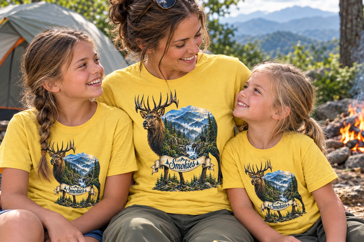 Mother and two daughters wearing matching yellow Smoky Mountains elk T-shirts while camping in the mountains