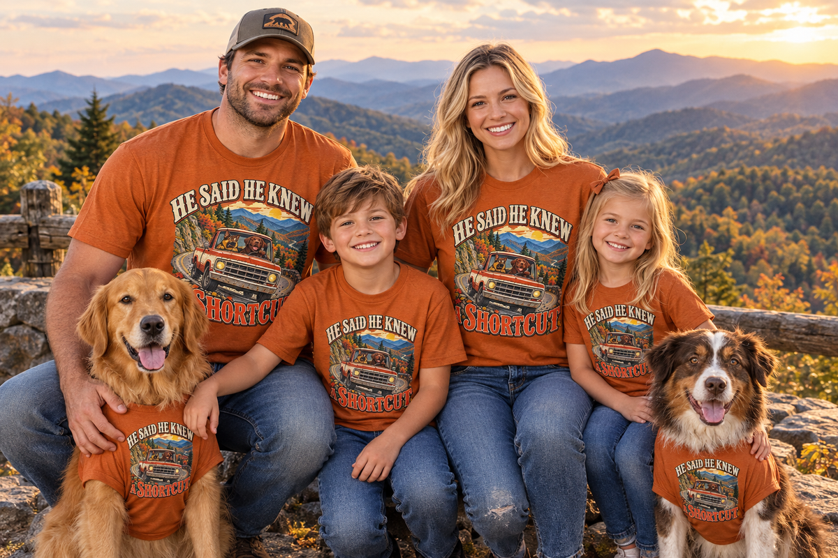 Family and two dogs wearing matching He Said He Knew a Shortcut T-shirts at a scenic overlook near Gatlinburg Tennessee