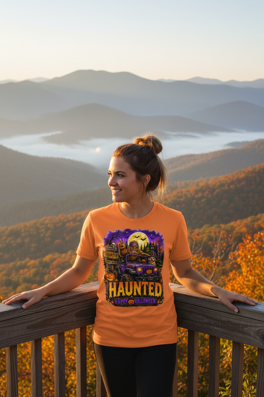 Woman wearing Haunted Bigfoot Halloween t-shirt at a scenic Appalachian mountain overlook in autumn
