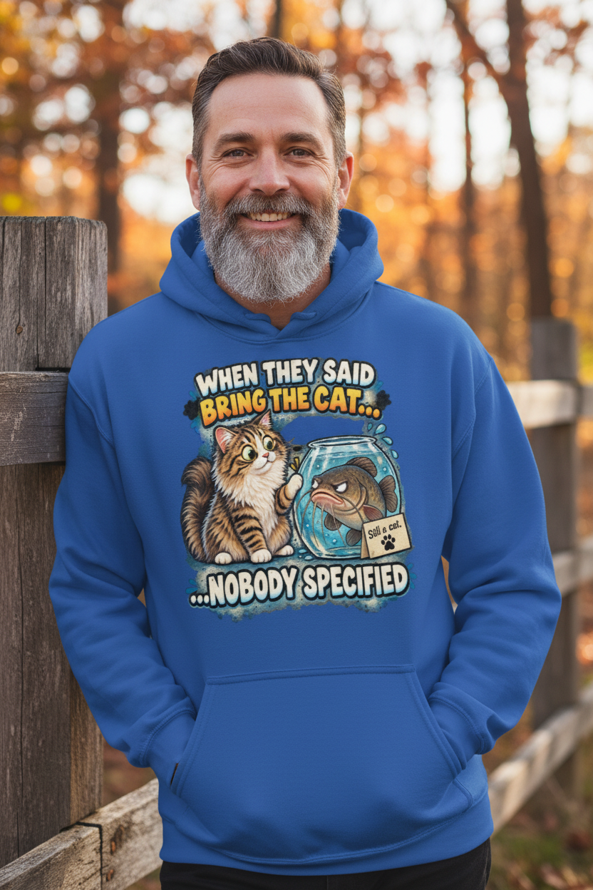 Man grinning in royal blue funny cat hoodie against rustic fence
