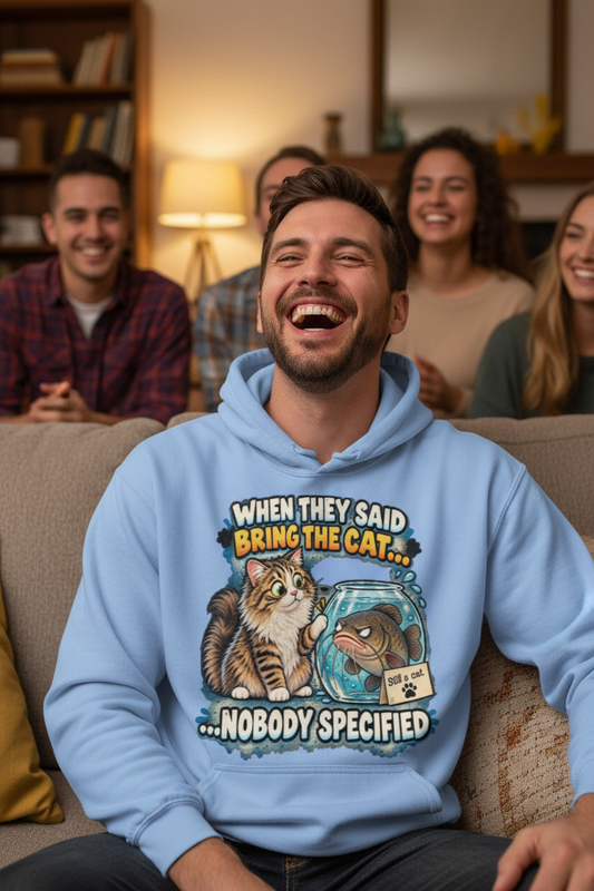 Man laughing in blue funny cat hoodie in cozy living room