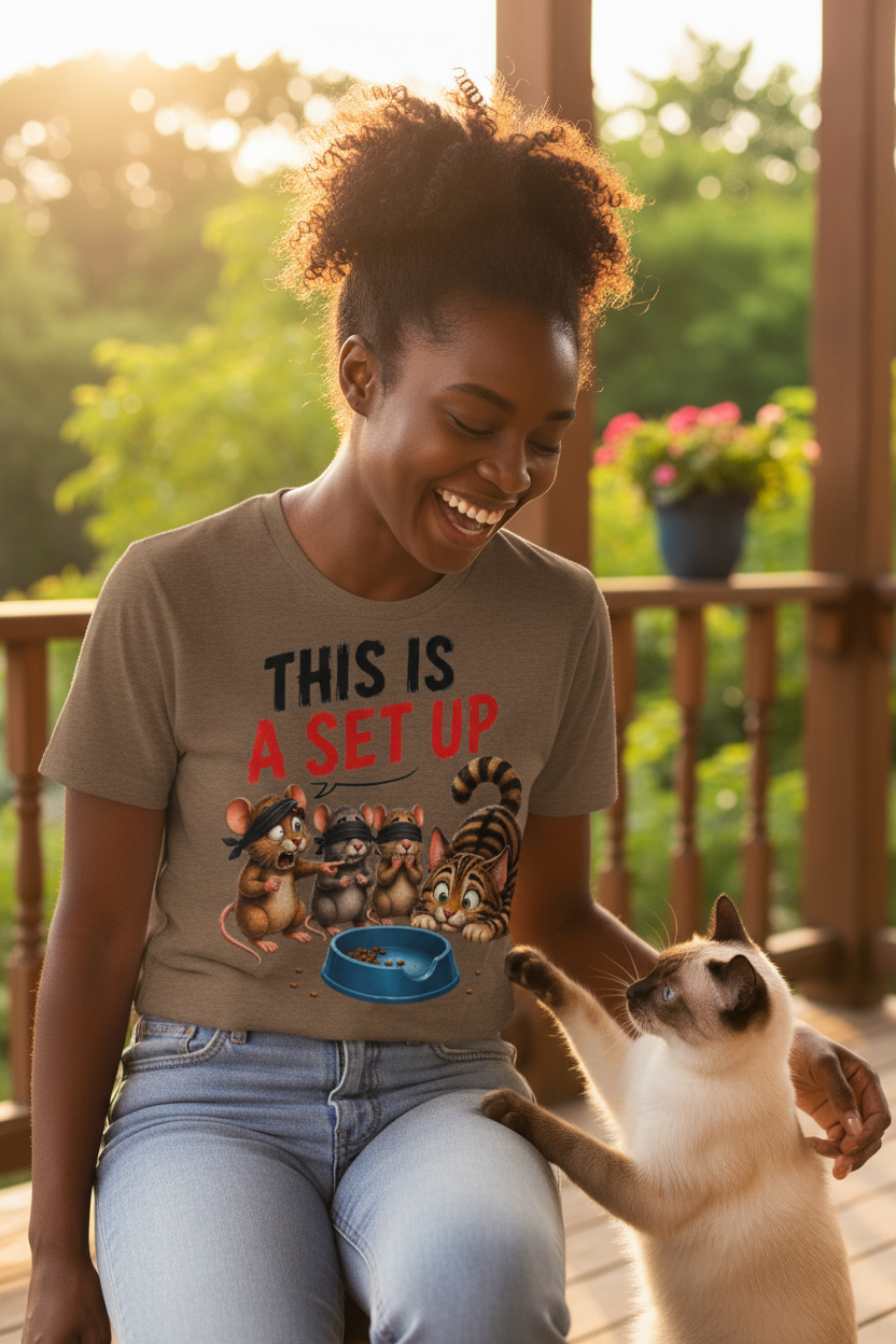 Woman with Siamese cat pawing shirt