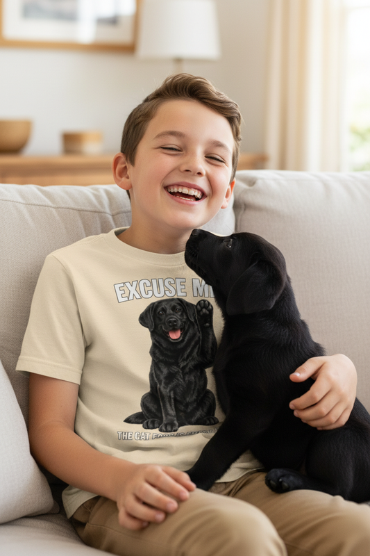 Young boy with black lab puppy, cream tee zoomed in